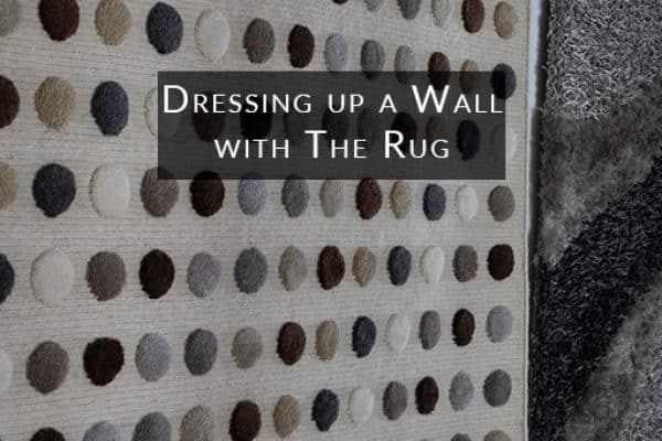 Dressing-up-a-wall-with-The-rug-p9ux49c9zxjs9a4xrnm9t7wr770nefrj1zmfw1qd28 home décor rugs